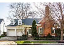 Charming brick home with a well-manicured front yard and attached two-car garage, blending classic style with modern convenience at 8037 Lynch Ln, Indianapolis, IN 46250