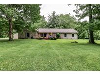 Charming one-story home with brick accents, a spacious yard, and mature trees at 1000 Janet Dr, Greenwood, IN 46142