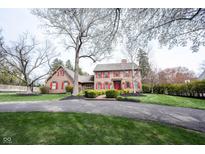 Charming two-story home with red shutters, a brick walkway and a well-manicured lawn at 13599 Brentwood Ln, Carmel, IN 46033