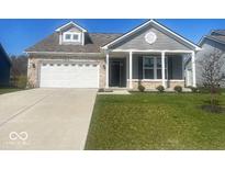 Charming single-Gathering home with a two-car garage, well-manicured lawn and a brick and vinyl facade at 1468 Lexington Trl, Greenfield, IN 46140