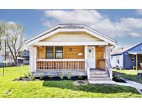 Charming single-story home featuring a wood porch, new landscaping, and beautiful curb appeal at 1511 E Tabor St, Indianapolis, IN 46203