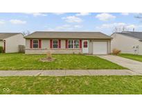Charming single-story home featuring a well-maintained front lawn and an attached one-car garage at 1517 Citation N Cir, Lebanon, IN 46052