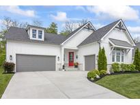 Charming home with a two-car garage, red door, and a beautifully landscaped front yard at 16422 Brigham Ln, Westfield, IN 46074