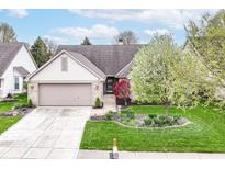 Charming single-story home featuring manicured lawn, brick facade, and attached two-car garage at 18009 Sun Ridge Cir, Noblesville, IN 46062