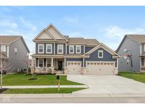 Beautiful two-story home with a three-car garage, front porch, and well-manicured lawn at 2208 Dudley Ave, Westfield, IN 46074