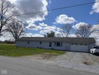 Charming single-story home with light siding, a attached garage, and a neatly kept lawn at 2715 S 300 E, Anderson, IN 46017