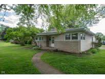 Charming ranch-style home with stone accents, manicured lawn, and mature trees provides great curb appeal at 3140 Bonham Dr, Indianapolis, IN 46222