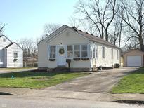 Charming home exterior featuring a wreath on the front door, cozy window planters, and a long driveway at 3233 N Tacoma Ave, Indianapolis, IN 46218