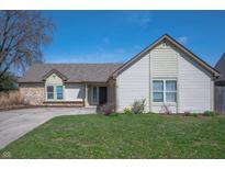 Charming single-story home featuring stone accents, light siding, and a well-maintained front lawn at 3510 Oak Tree Cir, Indianapolis, IN 46227