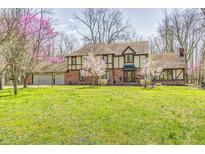 Beautiful two-story home with a well-manicured lawn and mature trees, offering a serene and inviting atmosphere at 3753 Whippoorwill Lake S Dr, Monrovia, IN 46157