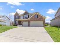 Two-story brick home with a spacious driveway and attached two-car garage at 419 Dovetree Dr, Danville, IN 46122