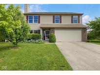Charming two-story home with well-manicured lawn and inviting curb appeal showcasing the welcoming facade at 518 Carthage Cir, Westfield, IN 46074