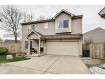 Charming two-story home featuring a two-car garage and a cozy front porch at 591 Scotch Pine Dr, Greenwood, IN 46143