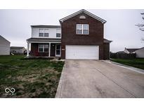 Charming two-story home with a brick facade and attached two-car garage, complemented by a well-maintained lawn at 729 Stonehenge Way, Brownsburg, IN 46112