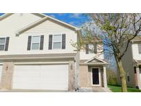 Charming townhome showcasing neutral siding, dark shutters, and an attached garage at 1139 Topp Creek Dr, Indianapolis, IN 46214