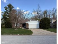 Charming single-story brick home featuring an attached two-car garage and well-maintained landscaping at 1348 Secretariat Ln, Indianapolis, IN 46217