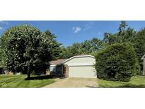 Lovely single-story home featuring a brick facade, attached garage, and a beautifully landscaped front yard at 1348 Secretariat Ln, Indianapolis, IN 46217