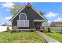 Charming home with a well-manicured lawn, a welcoming porch, and a unique architectural design at 3015 S Rybolt Ave, Indianapolis, IN 46241