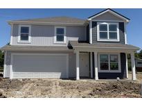 Charming two-story home featuring gray and navy siding, complemented by white trim and an attached two-car garage at 3297 Godby Dr, Sheridan, IN 46069