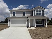 Newly constructed two-story home featuring a two-car garage, covered porch, and mixed siding at 3297 Godby Dr, Sheridan, IN 46069