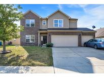 Traditional two-story home with brick and siding, attached three-car garage and manicured lawn at 3529 Miesha Dr, Indianapolis, IN 46217