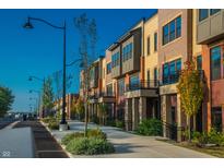 A row of modern townhouses featuring unique architectural designs and manicured landscaping at 388 S Meridian Unit A-Bldg C St # A, Greenwood, IN 46142