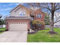 Charming two-story home features brick and siding, a two-car garage, and a well-maintained front lawn at 5343 Ripplingbrook Way, Carmel, IN 46033