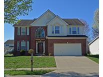 Charming two-story brick home with a well-manicured lawn and a two-car garage at 5639 Aquamarine Dr, Carmel, IN 46033