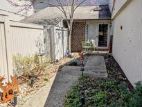 Inviting front yard with a charming walkway, garden bed, and seating area at 61 Osage Ct, Columbus, IN 47201
