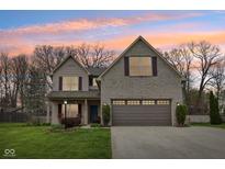 Charming two-story home with brick and vinyl siding and a well-manicured lawn at 6526 Angel Falls Dr, Noblesville, IN 46062