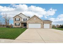 Charming two-story home with brick facade, three-car garage, and well-manicured lawn at 6707 Meadow View Ct, Avon, IN 46123
