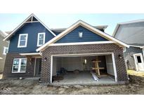 Two-story home with brick and blue siding with a two-car garage in the process of being built at 7308 Broadview Ln, McCordsville, IN 46055