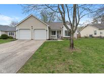 Charming home with a two-car garage and a well-maintained lawn, offering great curb appeal at 8747 Knotty Pine Ct, Indianapolis, IN 46227