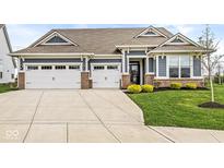 Beautiful home featuring a 3 car garage, nice landscaping, and a covered front porch at 9925 Glendon Ct, McCordsville, IN 46055