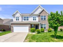 Charming two-story home featuring brick and siding, attached garage, and well-maintained landscaping at 10602 Pintail Ln, Indianapolis, IN 46239
