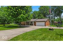 Charming single-story home with a well-maintained lawn, mature trees, and an attached two-car garage at 11054 N Shelby 490 W, New Palestine, IN 46163
