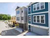 Beautiful new two-story home featuring a craftsman-style front exterior and attached garages at 13316 E Lieder Way, Fishers, IN 46037