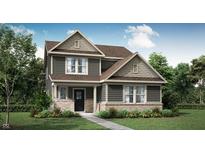 Charming two-story home with stone accents, a well-manicured lawn, and professionally landscaped shrubbery at 15379 Alperton Rd, Fishers, IN 46037
