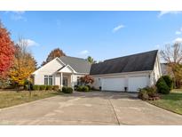 Stunning brick home featuring a spacious driveway, manicured landscaping and a three-car garage at 1853 Water Oak Ct, Avon, IN 46123