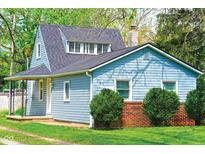 Charming single-Gathering home featuring blue siding, brick accents, and a well-maintained front yard at 2109 N Janney Ave, Muncie, IN 47304