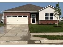 Inviting single-Gathering home featuring a manicured lawn, brick accents, and a two-car garage at 2212 Foothill Dr, Greenfield, IN 46140