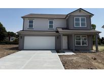 Charming two-story home with a two car garage and a concrete driveway at 24517 Wallace St, Sheridan, IN 46069