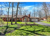 Charming single-story brick home with a well-maintained lawn and attached two car garage at 2979 Amherst St, Indianapolis, IN 46268