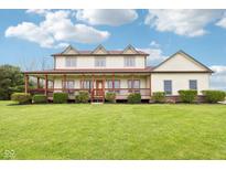Charming two-story home featuring a large covered porch and well-maintained landscaping on a lush green lawn at 4339 W Briarwood Rd, Monrovia, IN 46157