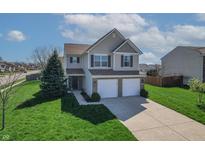 Inviting two-story home with a well-maintained lawn and a two-car garage at 5209 Twin Bridge Blvd, Indianapolis, IN 46239
