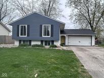 Charming home with a blue exterior, white trim, and a well-maintained lawn at 5240 Regency Dr, Columbus, IN 47203