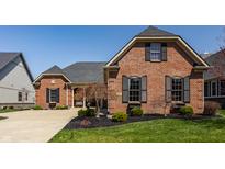 Beautiful brick home with manicured lawn, tasteful landscaping and black shutters at 528 Dylan Dr, Carmel, IN 46032