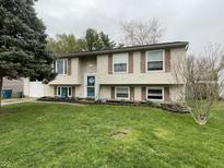 Charming two-story home featuring a well-manicured lawn, traditional siding, and inviting front door at 6225 Roberts Creek Ln, Indianapolis, IN 46221