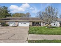 Charming single-story townhome with a one-car garage and well-manicured front lawn at 6742 S New Jersey St, Indianapolis, IN 46227