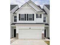 Charming two-story townhouse with a white facade, black shutters, and a spacious two-car garage at 7342 Shroyer Way, Noblesville, IN 46062